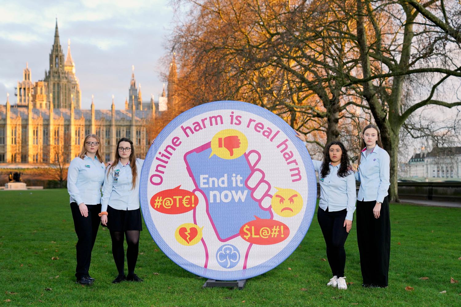 PA via ReutersEDITORIAL USE ONLY (Left to right) Advocates from Girlguiding UK, Caitlyn, Maddie, Fran and Phoebe, unveil a 2m x 2m Girlguiding badge with the words 'ONLINE HARM IS REAL HARM. END IT NOW' printed onto the material, before meeting with MPs to lobby for amends to be made to the Online Safety Bill, to include violence against young women and girls explicitly, Westminster, London. Picture date: Wednesday February 9, 2022.No Use UK. No Use Ireland. No Use Belgium. No Use France. No Use Germany. No Use Japan. No Use China. No Use Norway. No Use Sweden. No Use Denmark. No Use Holland. No Use Australia.