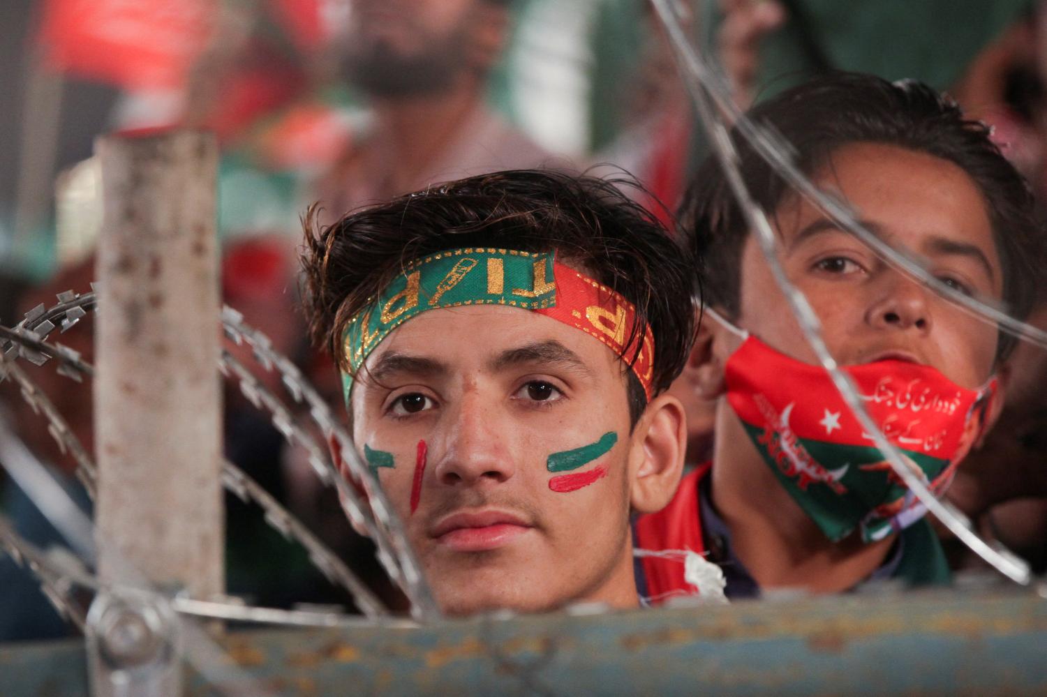 Supporters of the Pakistan Tehreek-e-Insaf (PTI) political party listen to the speech of the ousted Pakistani Prime Minister Imran Khan during a rally, in Lahore, Pakistan April 21, 2022. REUTERS/Mohsin Raza