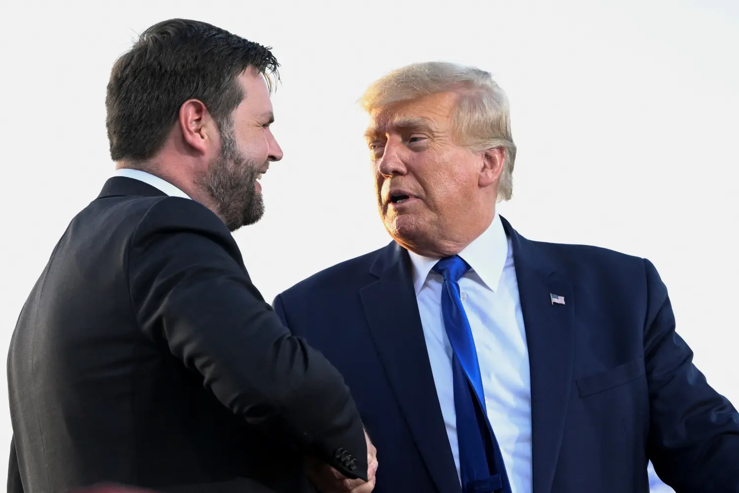 U.S. Senate Republican candidate J.D. Vance, who was endorsed by former U.S. President Donald Trump for the upcoming primary elections, shakes hands with Trump during an event hosted by him, at the county fairgrounds in Delaware, Ohio, U.S., April 23, 2022. REUTERS/Gaelen Morse