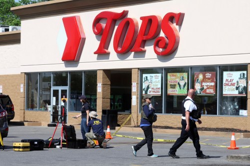 Members of the FBI and Buffalo Police Department collect evidence at the scene of a shooting at a TOPS supermarket in Buffalo, New York, U.S. May 15, 2022. REUTERS/Brendan McDermid