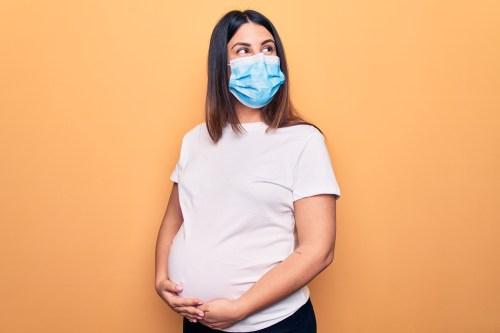 Pregnant woman wearing surgical mask