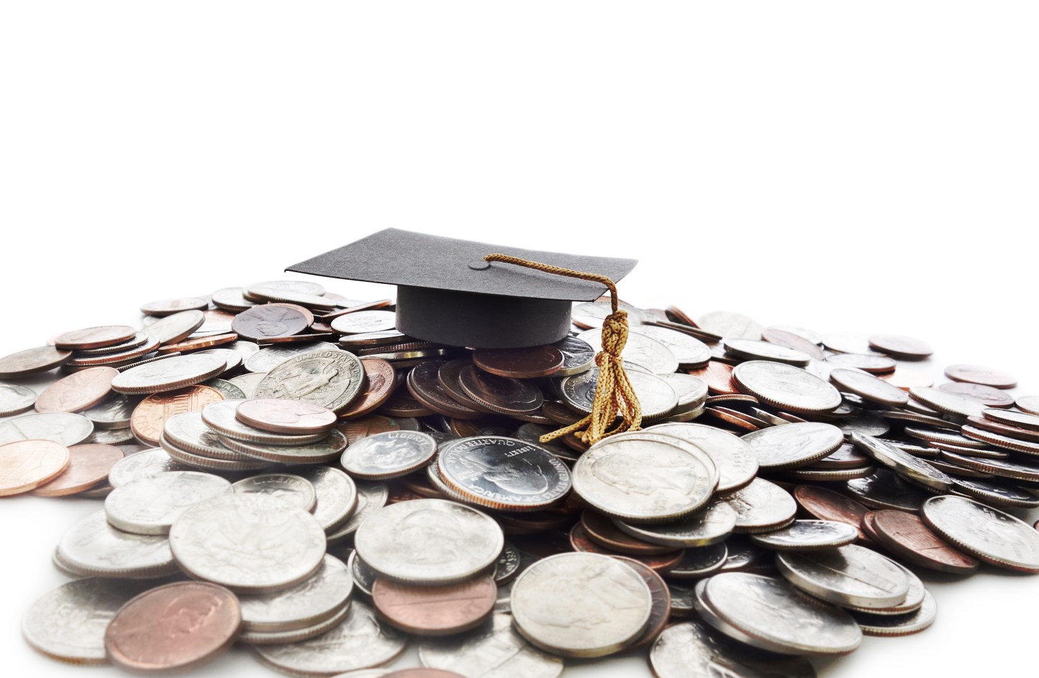 Paper graduation cap on a pile of coins.