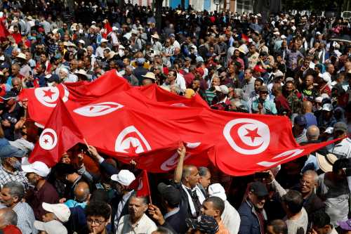 Demonstrators carry banners and flags during a protest against Tunisian President Kais Saied in Tunis, Tunisia May 15, 2022. REUTERS/Zoubeir Souissi