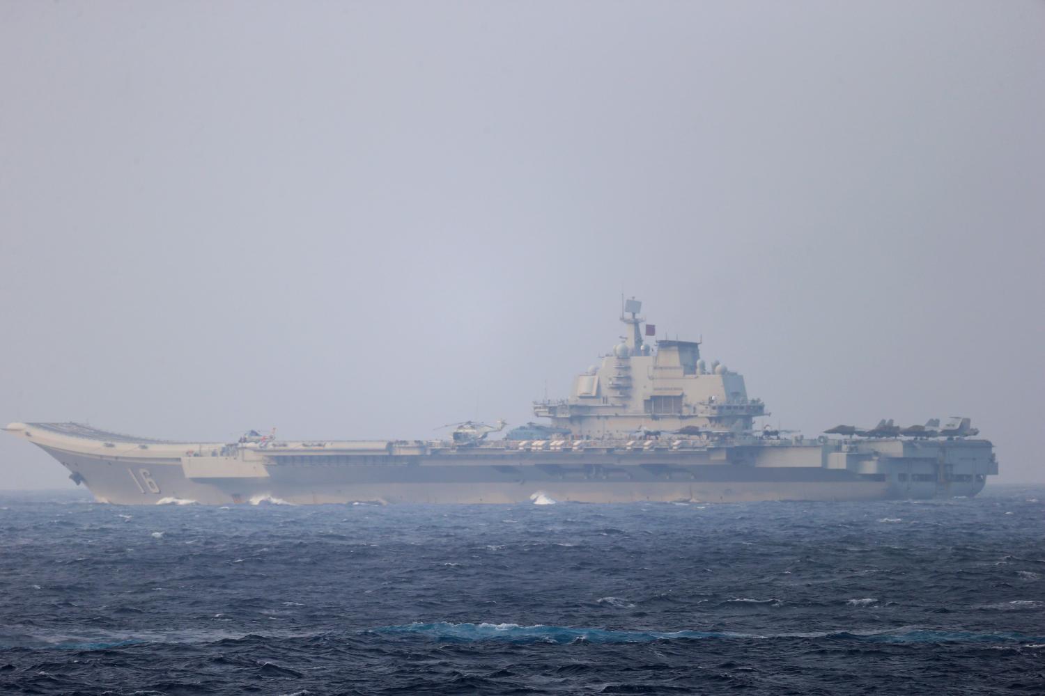 FILE PHOTO: Chinese aircraft carrier Liaoning sails through the Miyako Strait near Okinawa on its way to the Pacific in this handout photo taken by Japan Self-Defense Forces and released by the Joint Staff Office of the Defense Ministry of Japan on April 4, 2021. Joint Staff Office of the Defense Ministry of Japan/HANDOUT via REUTERS ATTENTION EDITORS - THIS IMAGE WAS PROVIDED BY A THIRD PARTY. MANDATORY CREDIT. THIS PICTURE WAS PROCESSED BY REUTERS TO ENHANCE QUALITY. AN UNPROCESSED VERSION HAS BEEN PROVIDED SEPARATELY/File Photo