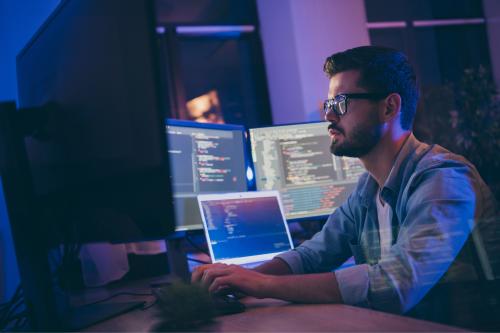 Man typing at computer