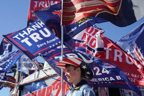 A boy waits before attending a rally where former U.S. President Donald Trump is to speak, in Conroe, Texas, U.S., January 29, 2022. REUTERS/Go Nakamura