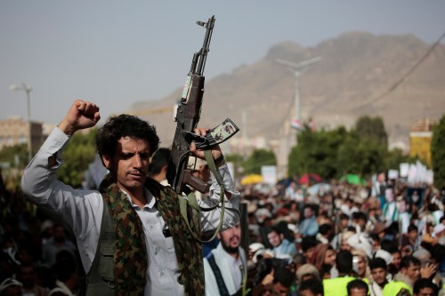 A houthi supporter carries a weapon during a protest against USA and Saudi Arabia calling on the end of war in Yemen, a day after the truce was renewed in Sanaa.