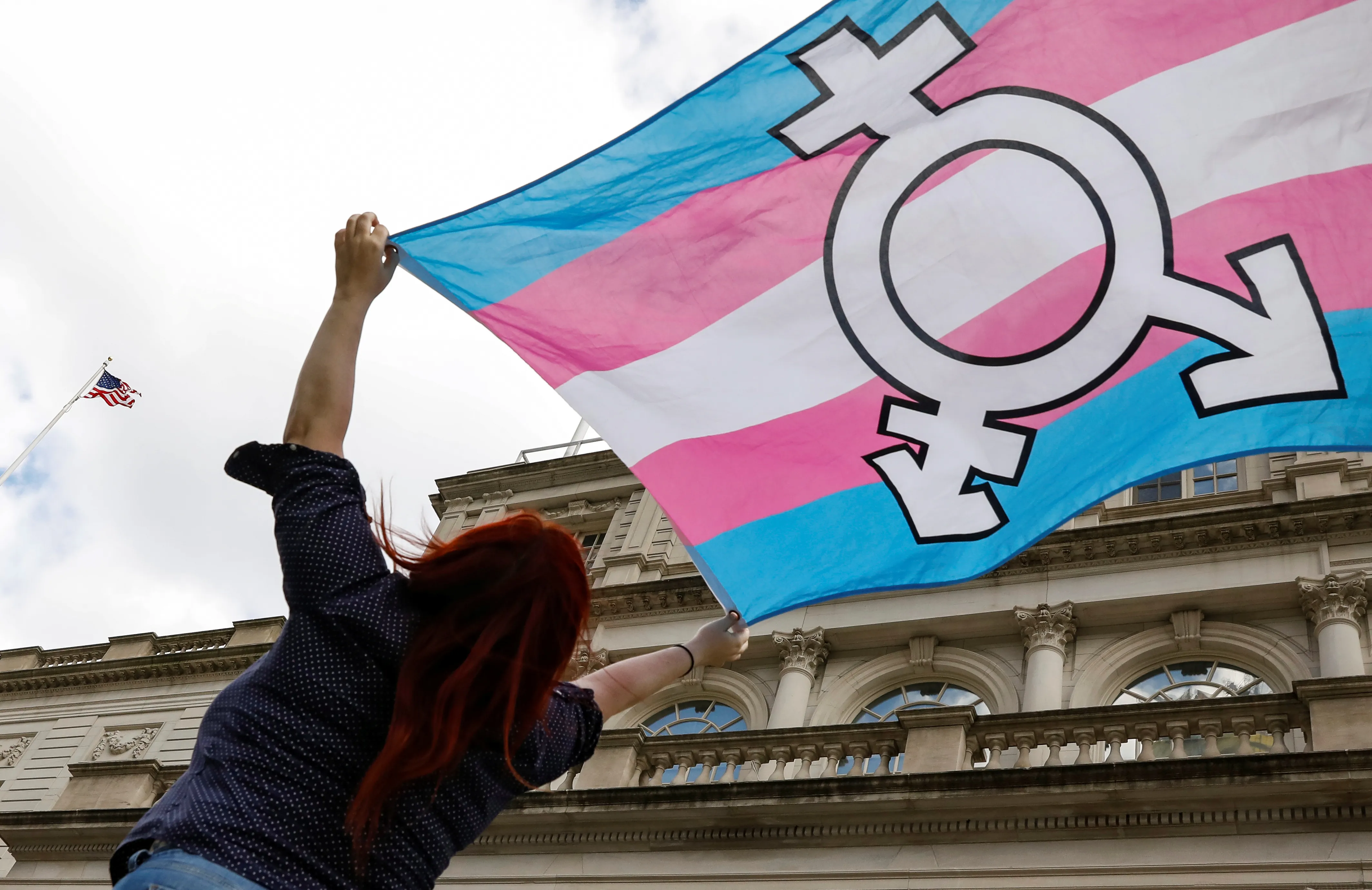 FILE PHOTO: A person holds up a flag during rally to protest the Trump administration's reported transgender proposal to narrow the definition of gender to male or female at birth, at City Hall in New York City, U.S., October 24, 2018. REUTERS/Brendan McDermid