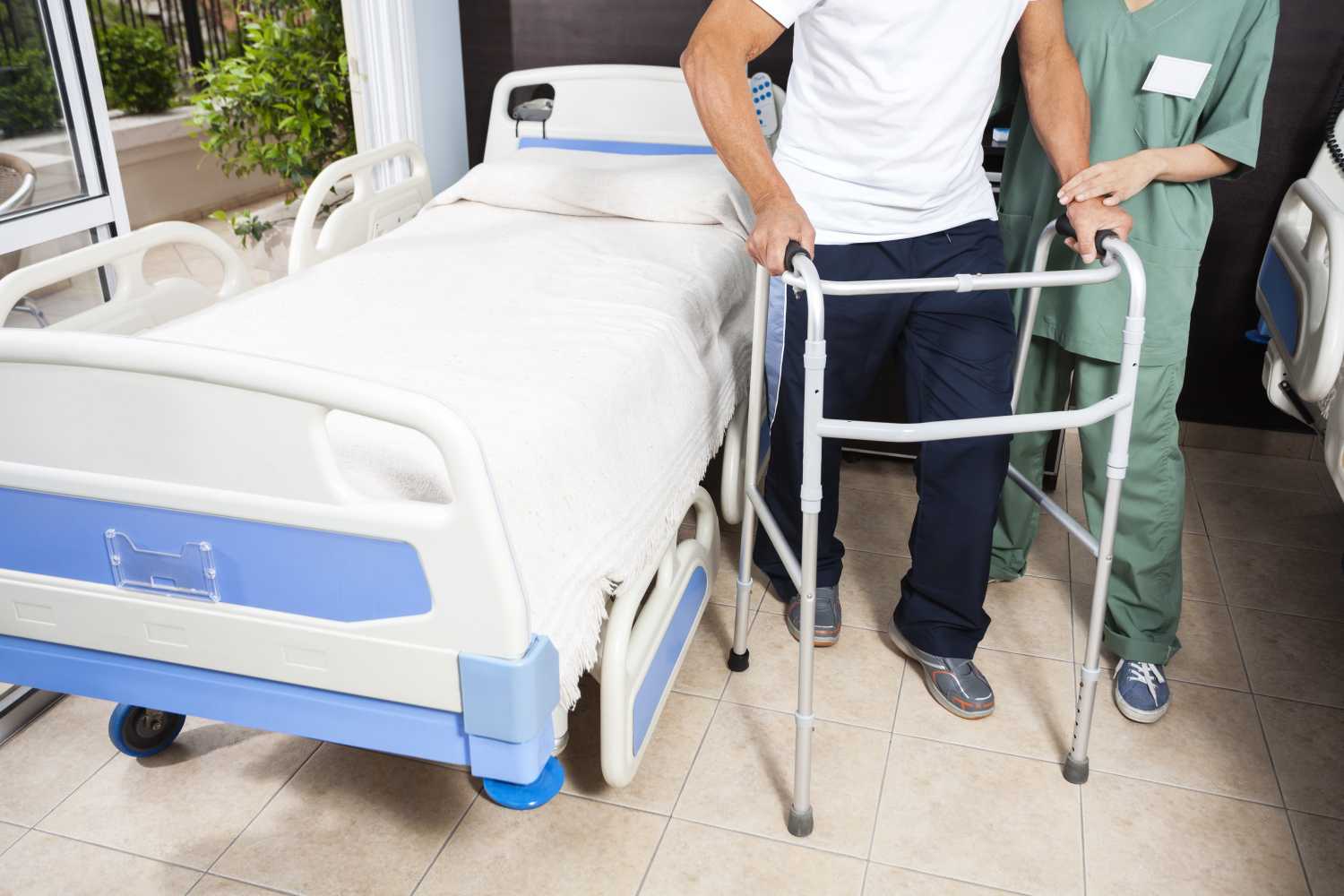 Nurse helping person with a walker