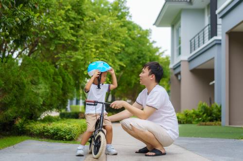 Father teaching son how to ride a bike