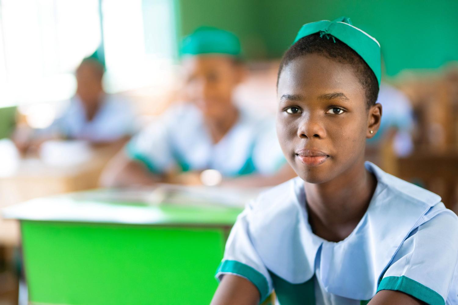 A student in Nigeria sits in the classroom.