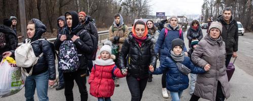 Ukraine refugees walk down the street.
