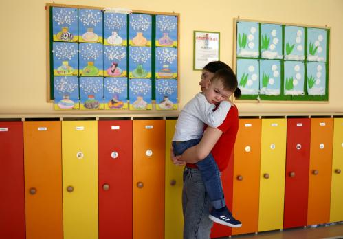 Ukrainian refugee Daniel Dyka, 3, from Chervonograd, is comforted by his mother, Ania Dyka, before entering a classroom with Polish children, after the Benedictine Sisters Monastery welcomed refugee children into their kindergarten, amid Russia's invasion of Ukraine, in Jaroslaw, Poland