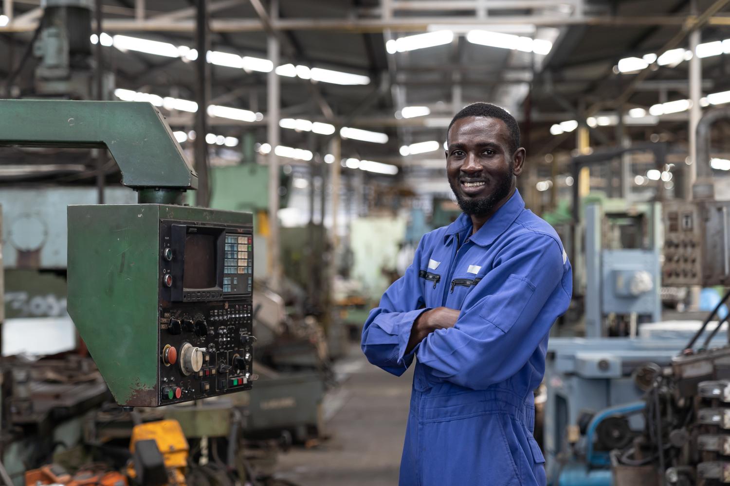 Portrait of smiling black male engineer at work in the industry factory.