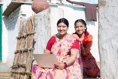 Rural Indian woman and daughter using a laptop