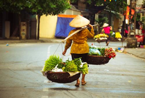 Women selling flowers in the early morning in a small market, Hanoi, Vietnam