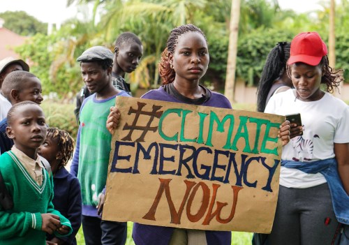 'Fridays for Future' coordinator Hilda Flavia Nakabuye holds a sign during the global 'School Strike for Climate' in Kampala, Uganda on May 24, 2019. Thomson Reuters Foundation/Alice McCool.