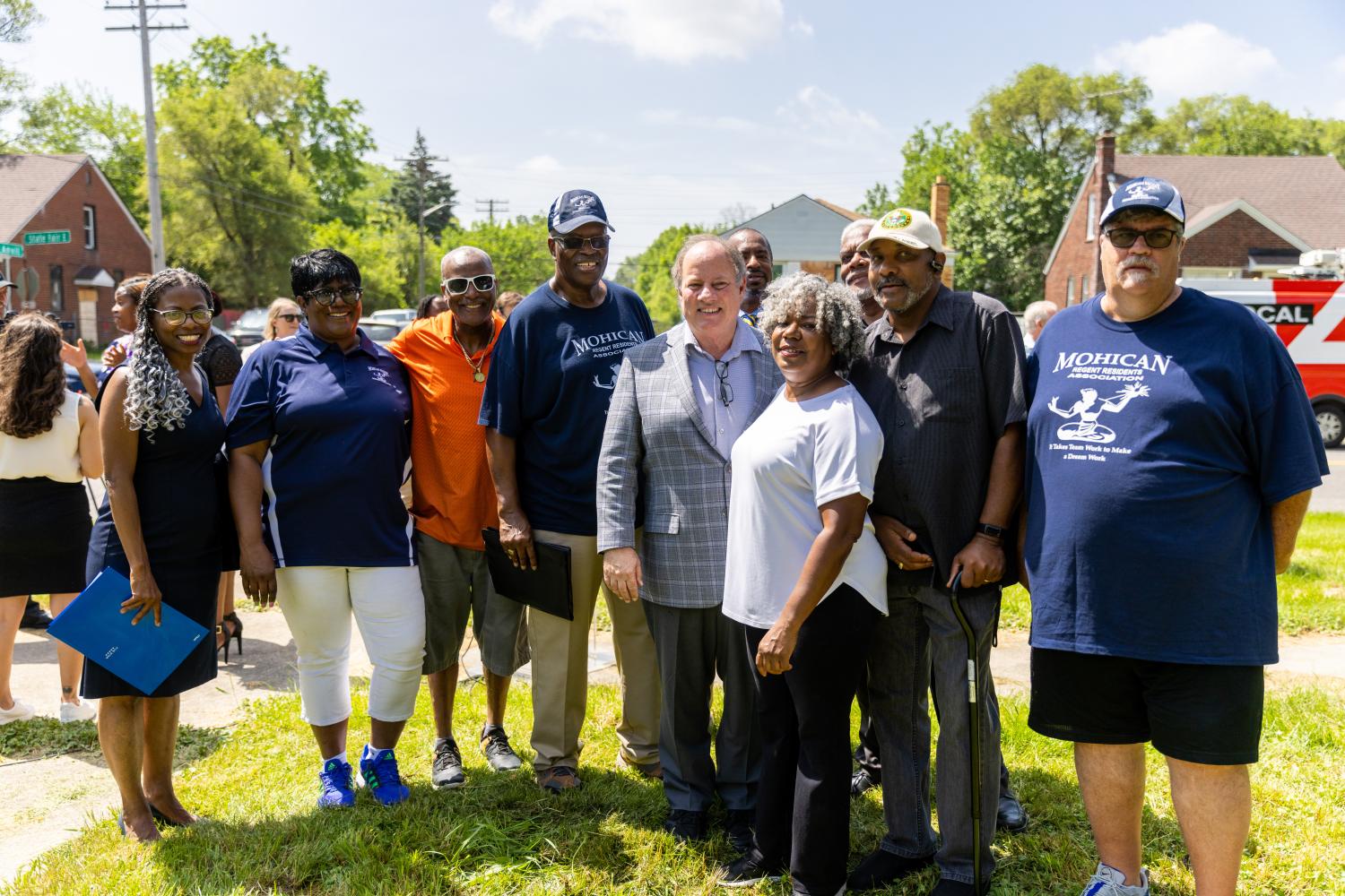 Group of 10 diverse people standing together outside for a photo in Detroit