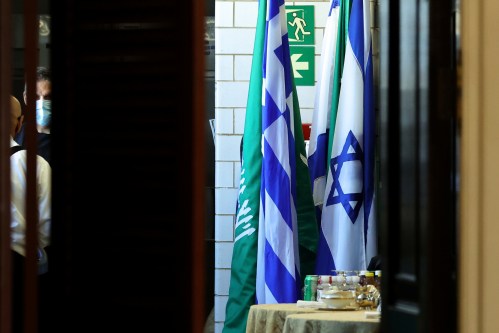 Flags of Saudi Arabia and Israel stand together in a kitchen staging area as U.S. Secretary of State Antony Blinken holds meetings at the State Department in Washington, U.S., October 14, 2021. REUTERS/Jonathan Ernst/Pool