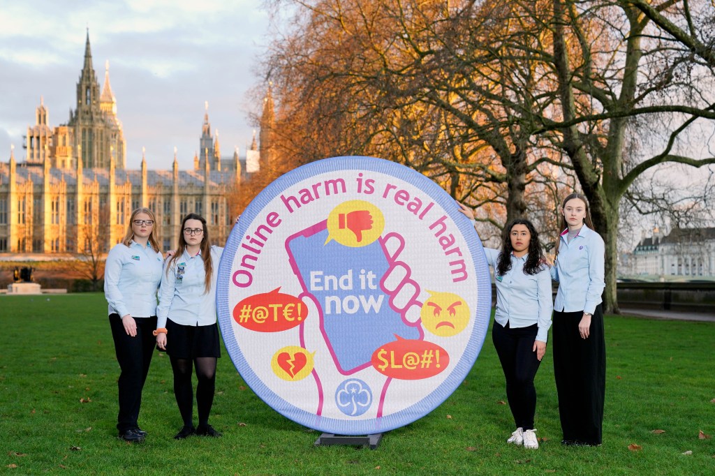 PA via Reuters
EDITORIAL USE ONLY (Left to right) Advocates from Girlguiding UK, Caitlyn, Maddie, Fran and Phoebe, unveil a 2m x 2m Girlguiding badge with the words 'ONLINE HARM IS REAL HARM. END IT NOW' printed onto the material, before meeting with MPs to lobby for amends to be made to the Online Safety Bill, to include violence against young women and girls explicitly, Westminster, London. Picture date: Wednesday February 9, 2022.No Use UK. No Use Ireland. No Use Belgium. No Use France. No Use Germany. No Use Japan. No Use China. No Use Norway. No Use Sweden. No Use Denmark. No Use Holland. No Use Australia.