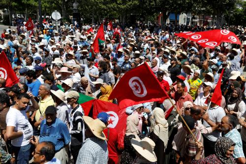 FILE PHOTO: Demonstrators hold flags as they gather during a protest against Tunisian President Kais Saied in Tunis, Tunisia June 19, 2022. REUTERS/Zoubeir Souissi/File Photo