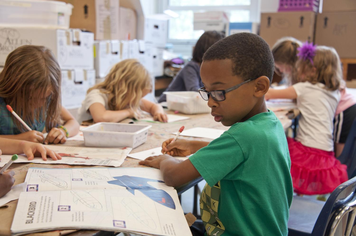 child sitting at desk working