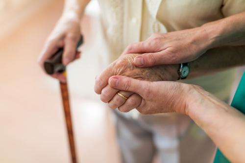 nurse consoling elderly man