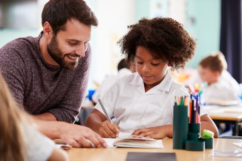 teacher with elementary student