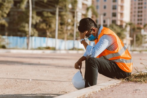 Construction worker sitting on curb