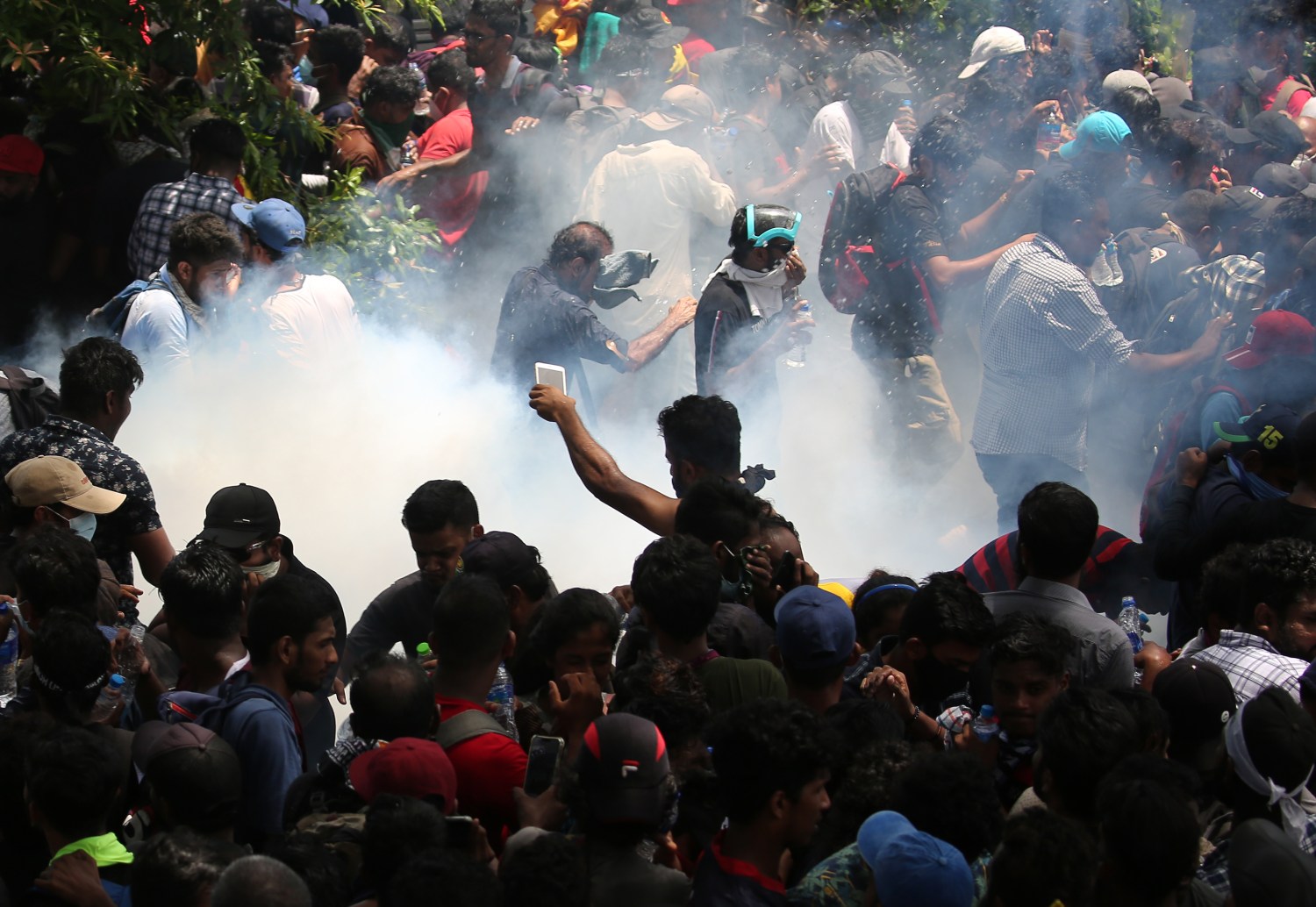 Police use tear gas as Protesters storm the compound of prime minister's office, demanding Ranil Wickremesinghe resign after president Gotabaya Rajapaksa fled the country amid economic crisis in Colombo, Sri Lanka,July 13, 2022. (Photo by Pradeep Dambarage/NurPhoto)NO USE FRANCE