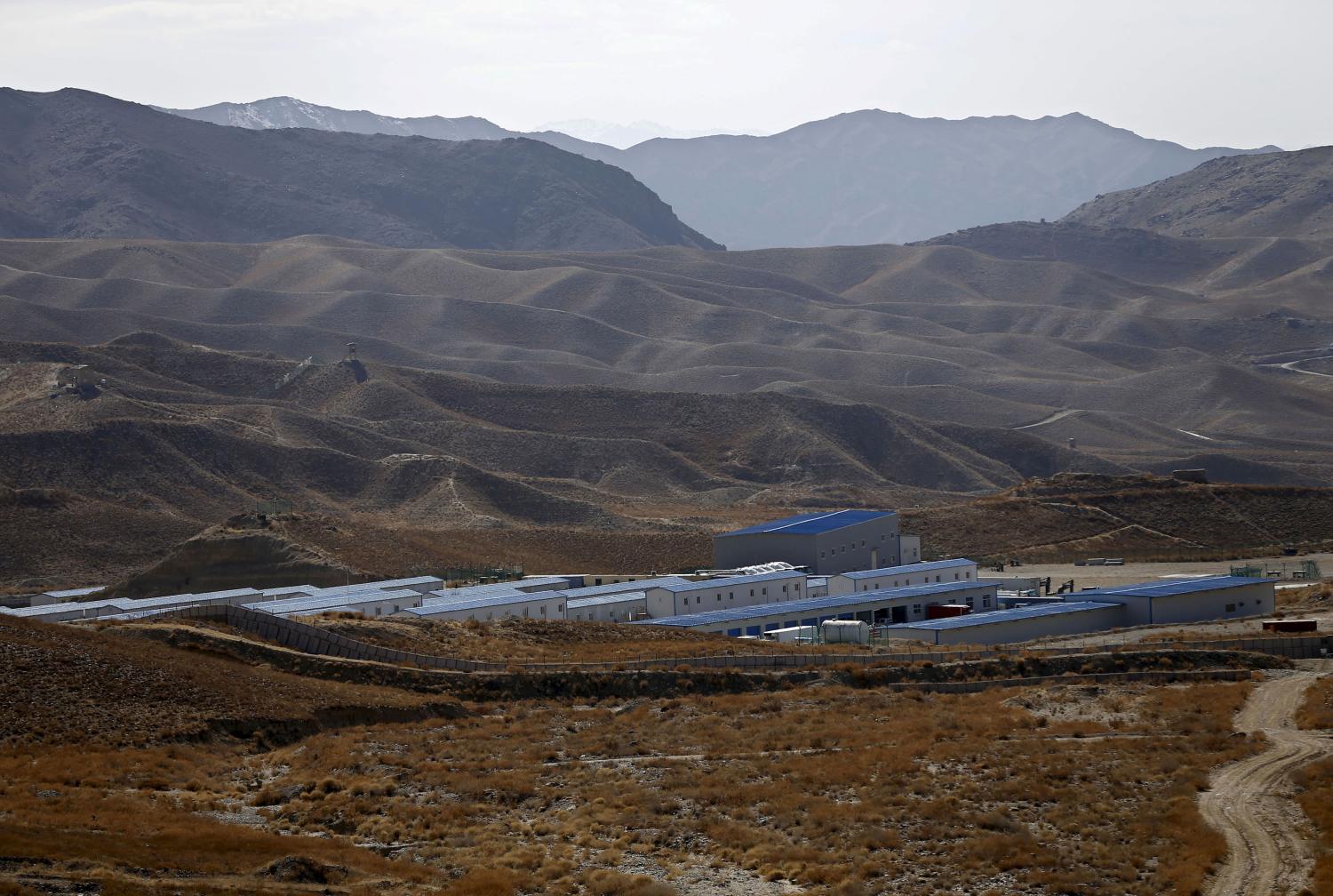 Installations used by Chinese excavators and engineers are seen at a copper mine in Mes Aynak, Logar province February 14, 2015. China and Afghanistan remain deadlocked over a stalled $3 billion copper mine five months after Beijing demanded royalties be slashed by almost a half, underlining Kabul's struggles to support itself as foreign aid dries up. The copper, lying beneath the ancient Buddhist ruins of Mes Aynak, is one of the world's largest untapped deposits. But the project has been mired in delays since state-run China Metallurgical Group Corp (MCC) won the contract to develop it in 2007. Resurgent Taliban insurgents have tightened control over the area around Aynak, and after threats, rocket attacks and the risk of land mines, MCC withdrew its Chinese workers from the heavily guarded copper camp last year. And then there are the Buddhist ruins. Archeological work to preserve treasures from the crumbling monastries and stupas is dangerous and slow, and must be finished before mining can begin. Picture taken on February 14, 2015. REUTERS/Omar Sobhani