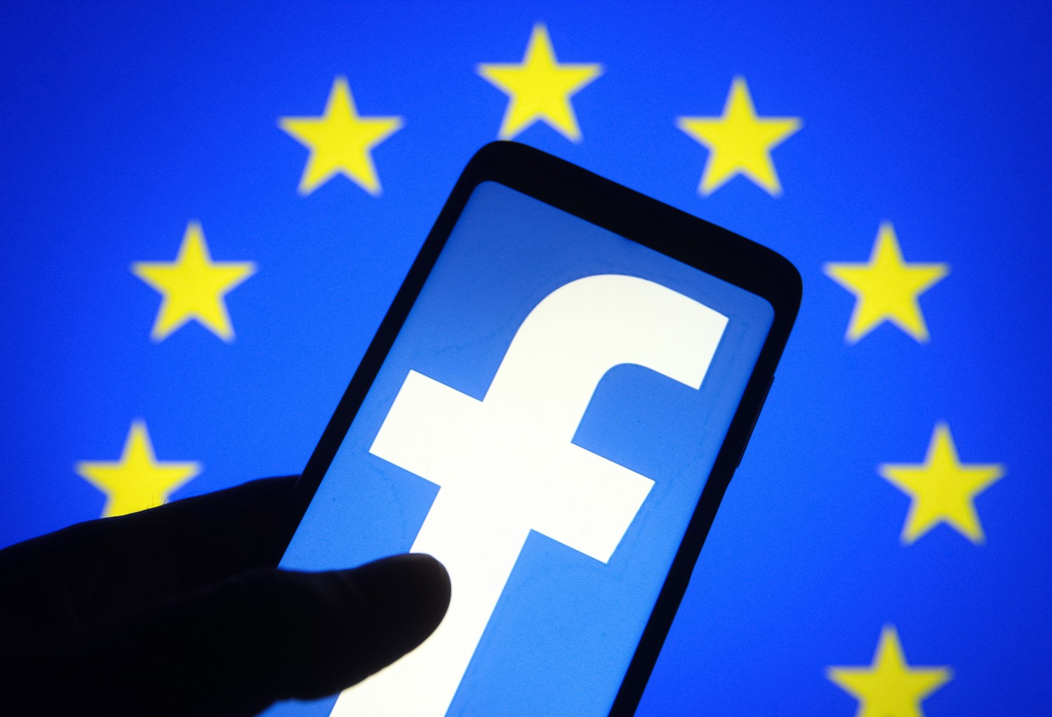 In this photo illustration, Facebook logo seen displayed on a smartphone screen and the European Union (EU) flag in the background. Facebook plans to create 10 000 jobs in the EU to build a 'Metaverse', reportedly by media. (Photo by Pavlo Gonchar / SOPA Images/Sipa USA)No Use Germany.