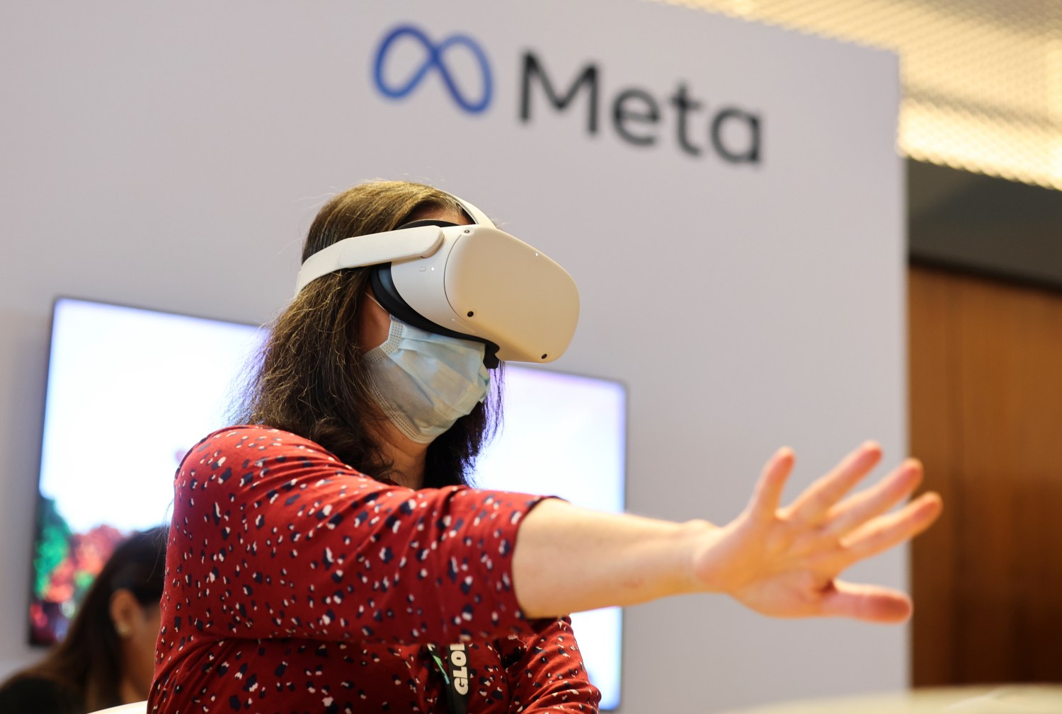 A person uses virtual reality headset at Meta stand during the ninth Summit of the Americas
