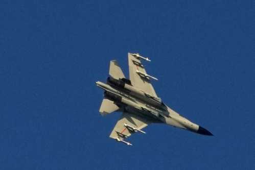 A Chinese People's Liberation Army (PLA) aircraft flies over the 68-nautical-mile scenic spot, one of mainland China's closest points to the island of Taiwan, in Pingtan island, Fujian province, China August 5, 2022. REUTERS/Aly Song