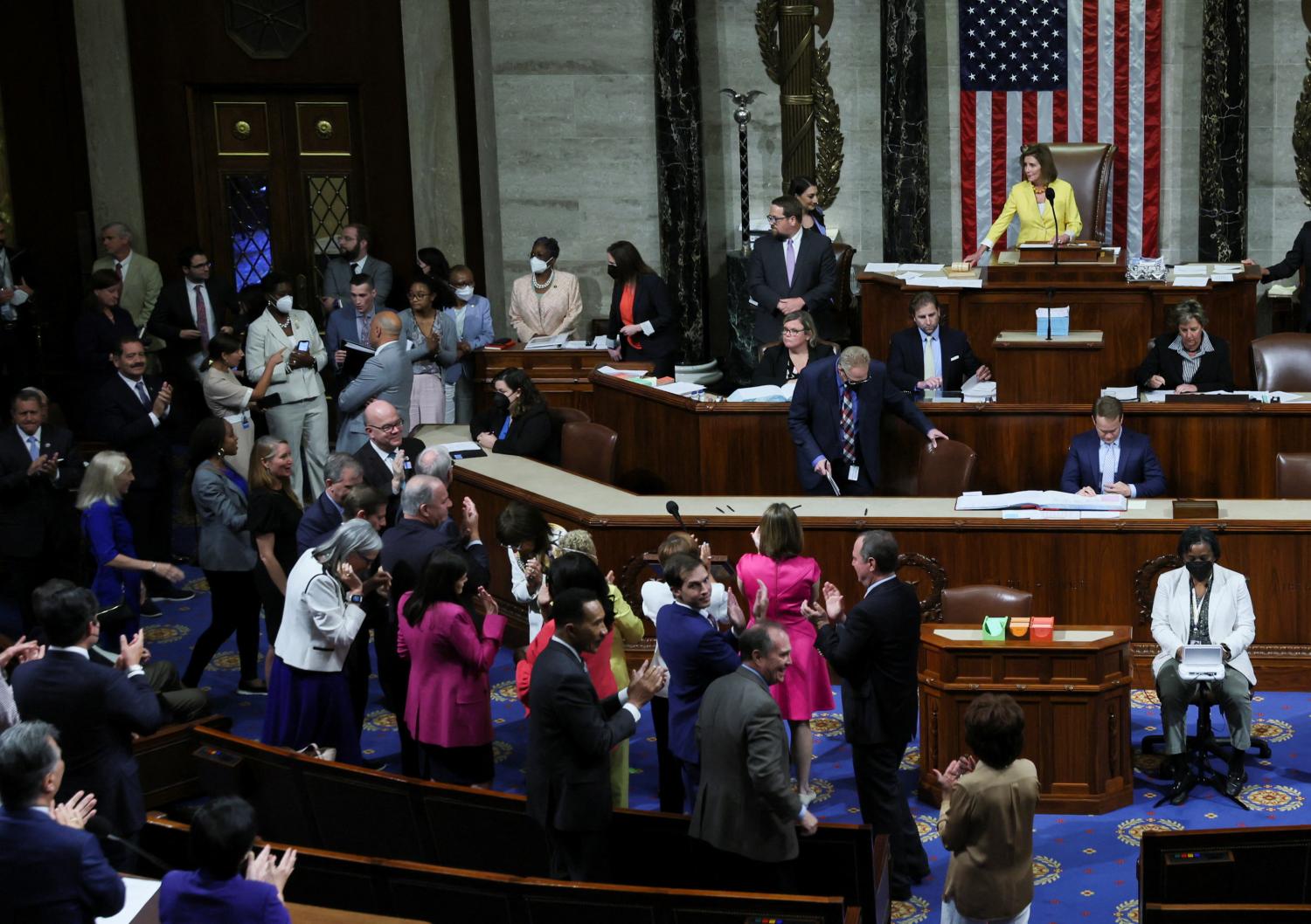 Democratic members of the U.S. House of Representatives applaud and celebrate as Speaker of the House Nancy Pelosi (D-CA) lays down her gavel after the House passed H.R. 6376, the "Inflation Reduction Act of 2022," which has already passed the U.S. Senate, in the House Chamber of the U.S. Capitol on Capitol Hill in Washington, August 12, 2022.   REUTERS/Leah Millis