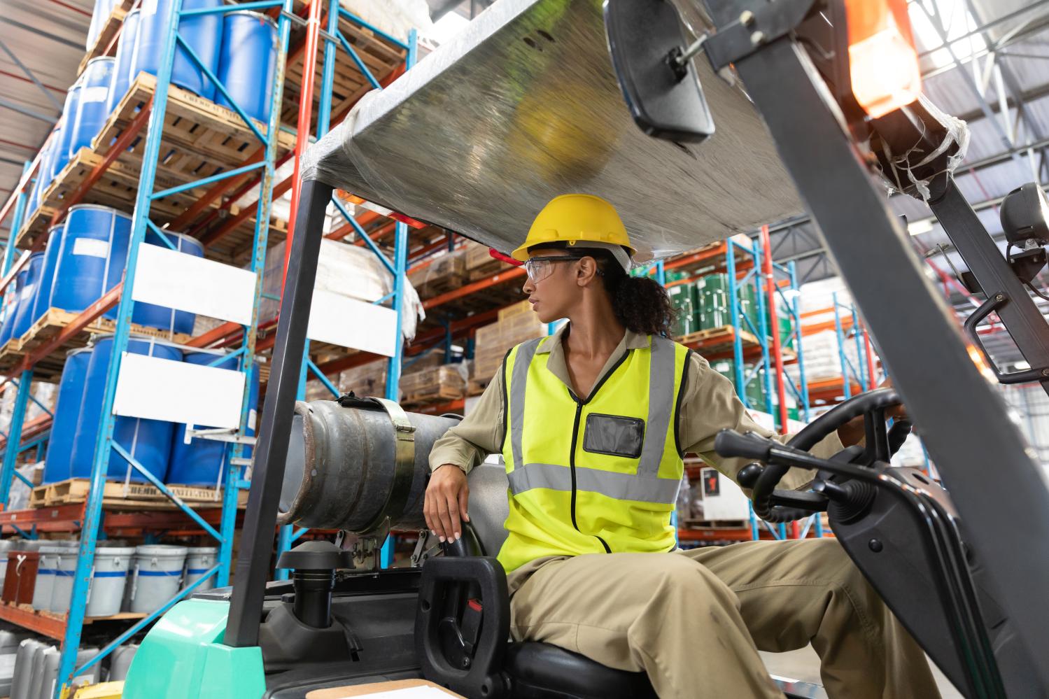 A woman drives a forklift