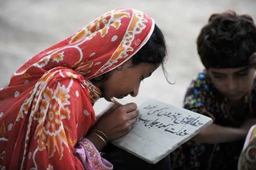 A Pakistani girl studies in the classroom.