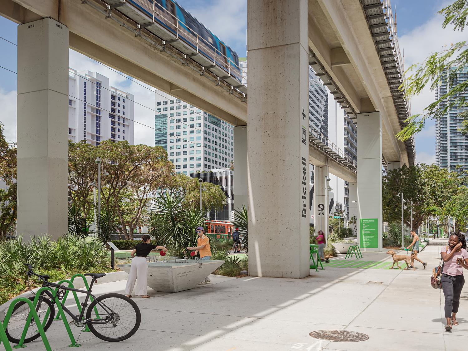 Miami, Florida, The Underline Promenade, people playing ping pong under outdoor rail system