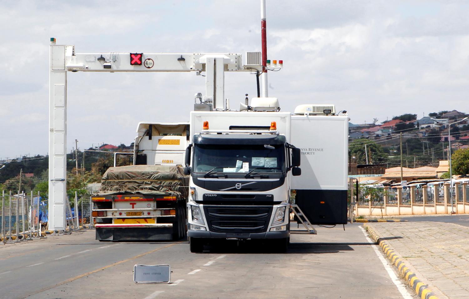 Transit trucks go through an electronic weighbridge at the border crossing point between Kenya and Tanzania in Namanga, Tanzania July 19, 2019. Picture taken July 19, 2019. REUTERS/Njeri Mwangi