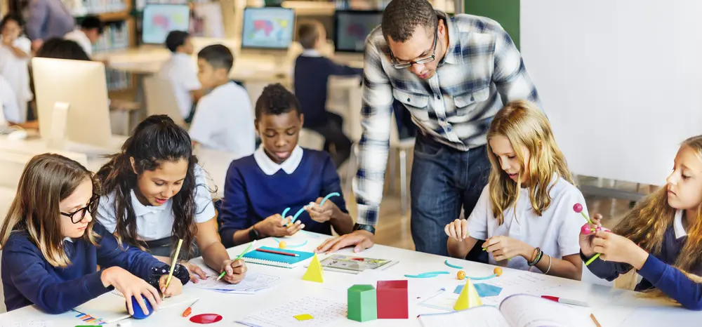 teacher looking at students work