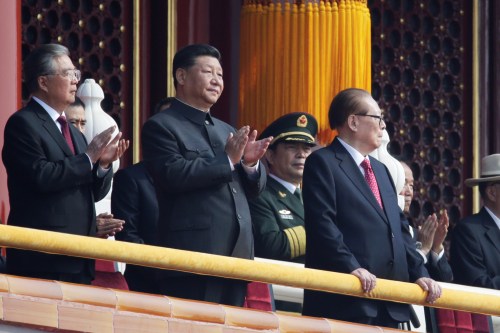 Chinese President Xi Jinping applauds as he stands between former presidents Hu Jintao and Jiang Zemin on Tiananmen Gate before the military parade marking the 70th founding anniversary of People's Republic of China, on its National Day in Beijing, China October 1, 2019. REUTERS/Jason Lee