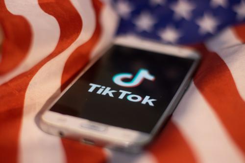TikTok closeup logo displayed on a phone screen, smartphone on the American flag or U.S. flag, the national flag of the United States are seen in this multiple exposure illustration. Tik Tok is a Chinese video-sharing social networking service owned by a Beijing based internet technology company, ByteDance.  It is used to create short dance, lip-sync, comedy and talent videos. ByteDance launched TikTok app for iOS and Android in 2017 and earlier in September 2016 Douyin fror the market in China. TikTok became the most downloaded app in the US in October 2018. President of the USA Donald Trump is threatening and planning to ban the popular video sharing app TikTok from the US because of the security risk.  On August 3, 2020 in Thessaloniki, Greece.(Photo by Nicolas Economou/NurPhoto)NO USE FRANCE