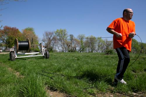Dave Wallace, owner of Silica Broadband, pulls fiber cable few foots at a time as he finishes the 82000 foot in order to provide internet to one of his clients in rural Louisville, Kentucky, U.S., April 19, 2021.  REUTERS/Amira Karaoud