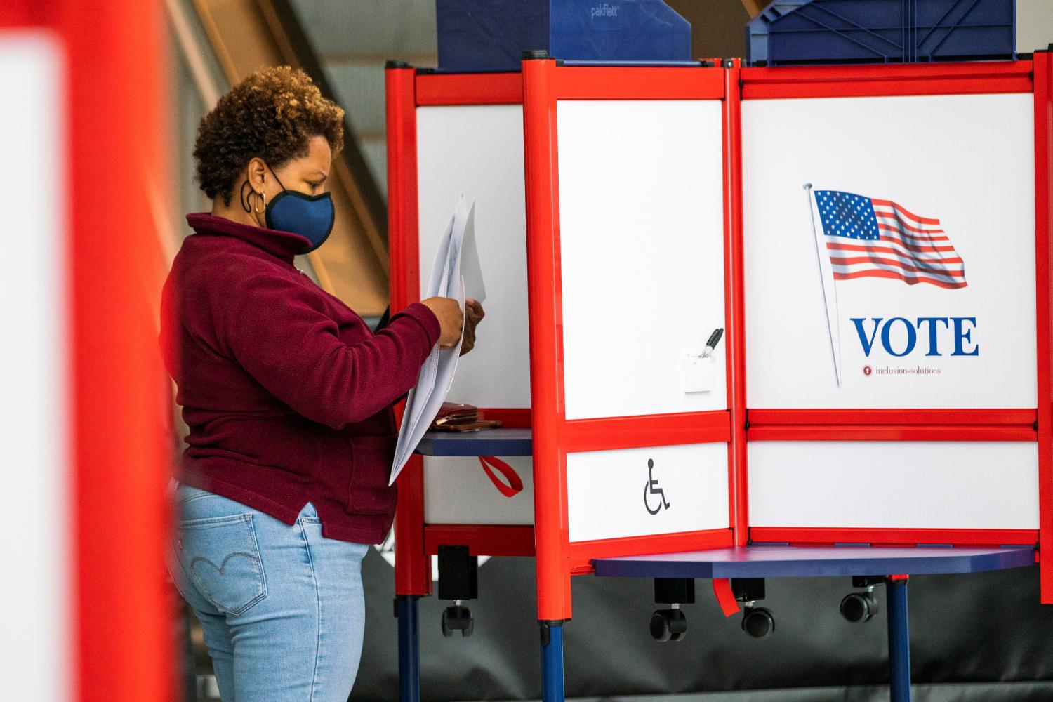 A woman fills her ballot in a privacy booth while voting in the gubernatorial election in Newark, New Jersey, U.S., November 2, 2021. REUTERS/Eduardo Munoz