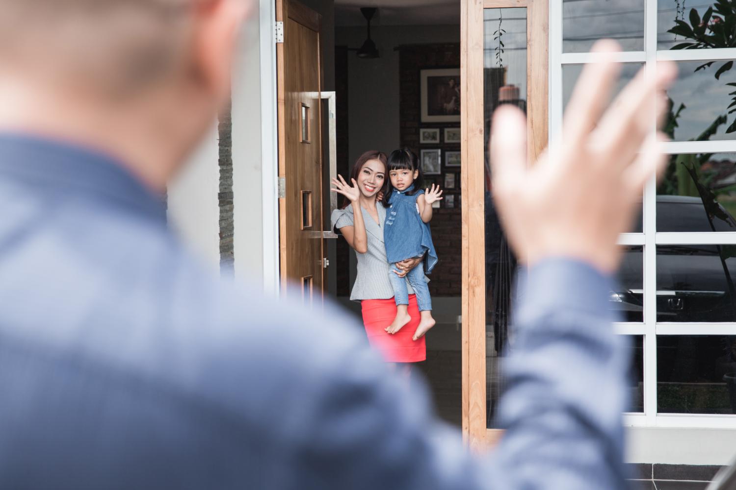 A mom and daughter wave goodbye