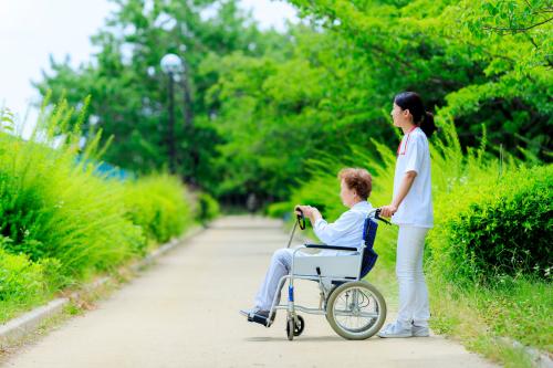 A woman and her caregiver in the park