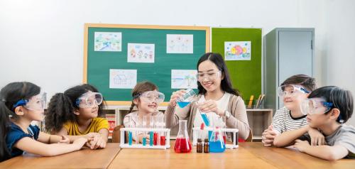 A classroom celebrates World Teachers' Day while doing a chemistry experiment.