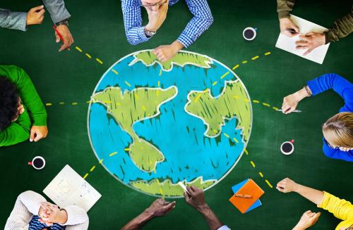 Students study around a big globe.