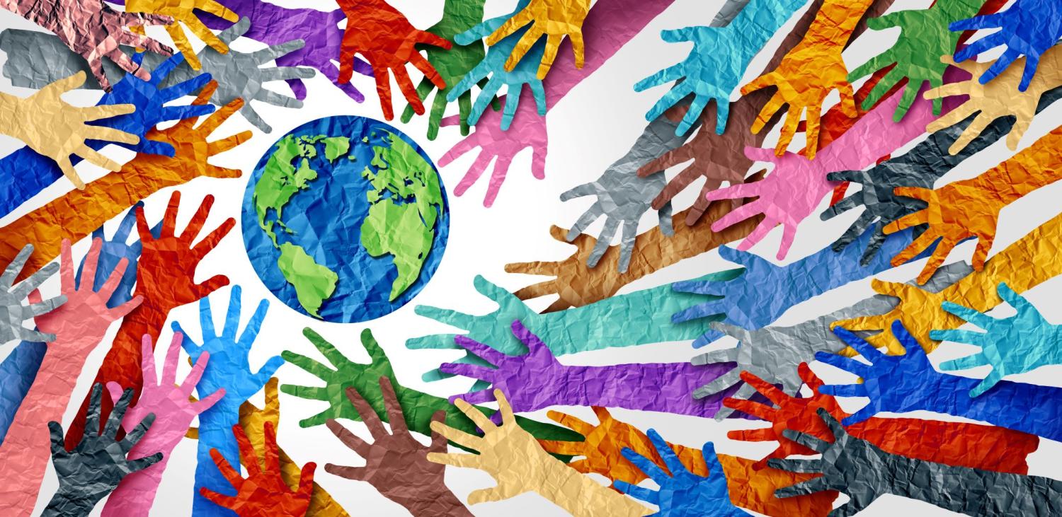 Hands come together to support the Earth.