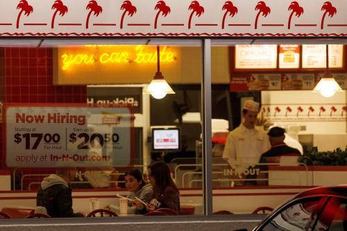 FILE PHOTO: A "Now hiring" sign is displayed on the window of an IN-N-OUT fast food restaurant in Encinitas, California, U.S., May 9, 2022. REUTERS/Mike Blake/File Photo/File Photo